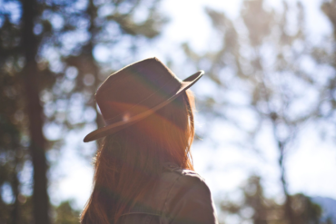 Girl in Fedora Staring at the Sun Christian Stock Photo